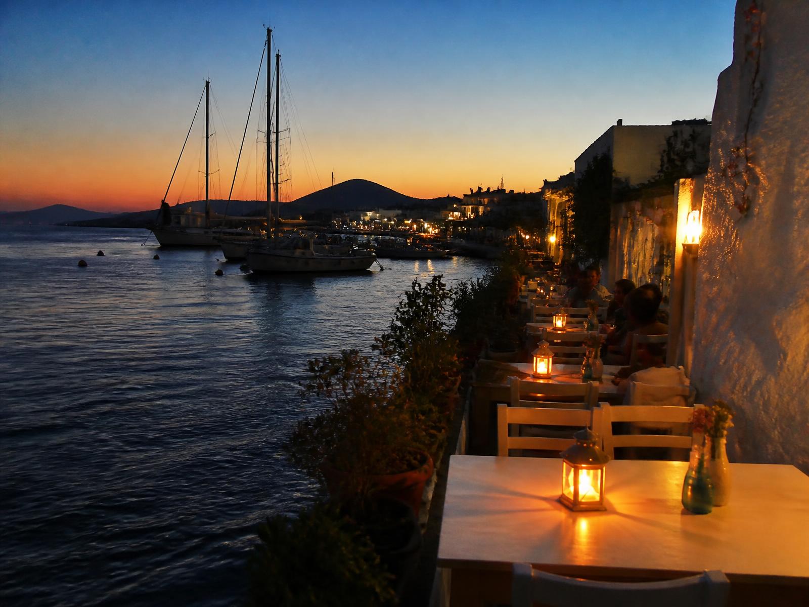 Waterside tables and moored boats in Bodrum at dusk